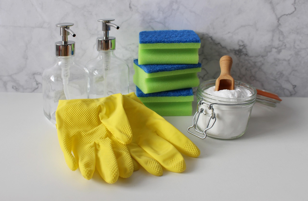 Cleaning gloves, sponges and supplies arranged on a countertop